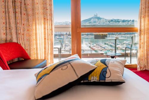 a hotel room with a bed and a window at La Residence Du Vieux Port in Marseille