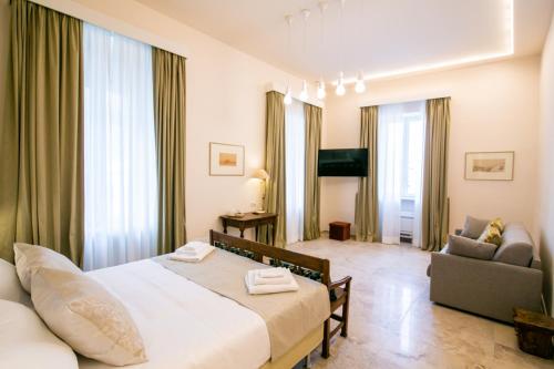 a hotel room with a bed and a couch at Migliori Olive Ascolane beds in Ascoli Piceno