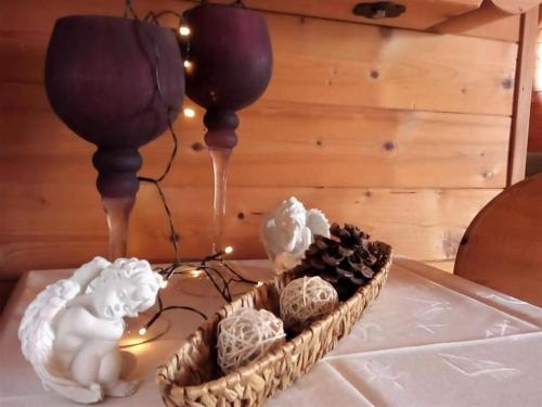 a table with a basket of flowers and candles at Opas Bergchalet in Halblech