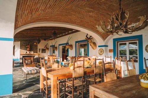 a dining room with a wooden table and chairs at Vale Do Manantio in Moura