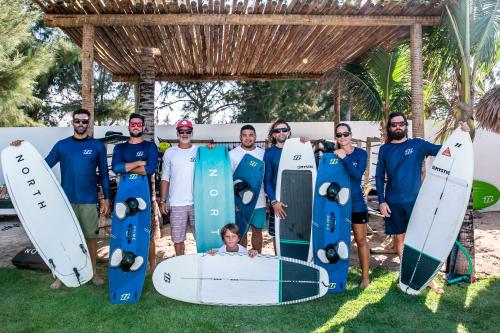 a group of men standing next to their surfboards at Preabeach Boutique Hotel & SPA in Prea