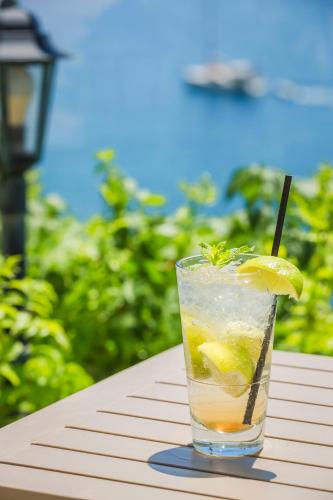 a drink on a table with a lemon slice in it at Kefalonia Bay Palace in Kefallonia