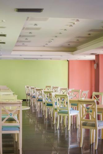 a row of tables and chairs in a room at Kefalonia Bay Palace in Kefallonia