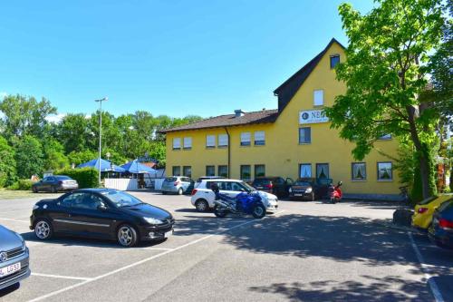 un estacionamiento frente a un edificio amarillo en Hotel und Restaurant Nehrener Hof, en Nehren