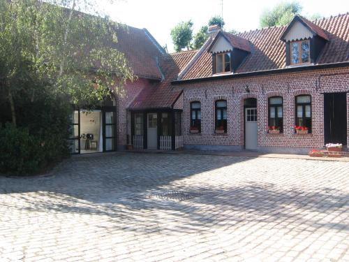 a brick house with a driveway in front of it at Gîte Du Haut Ballot in Wambrechies