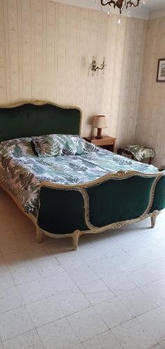 a large green bed sitting in a room at ML83 in Sanary-sur-Mer