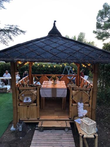 a wooden gazebo with a table in it at ML83 in Sanary-sur-Mer