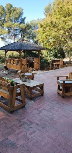a picnic area with picnic tables and a gazebo at ML83 in Sanary-sur-Mer