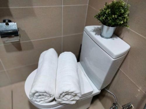 a toilet with a potted plant on top of it at Link 2 Residence Bukit Jalil I HomeBrickz in Kuala Lumpur