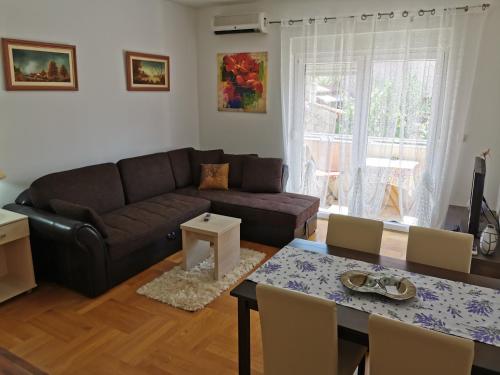 a living room with a couch and a table at Apartments Mara Cres in Cres