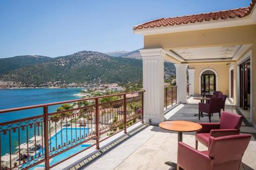 a balcony with a view of the water and mountains at Kefalonia Bay Palace in Kefallonia