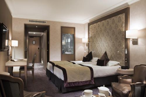 Ένα ή περισσότερα κρεβάτια σε δωμάτιο στο Grand Hôtel Des Thermes