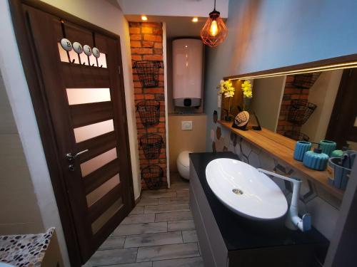 a bathroom with a sink and a mirror at Apartment Keleia in Celje