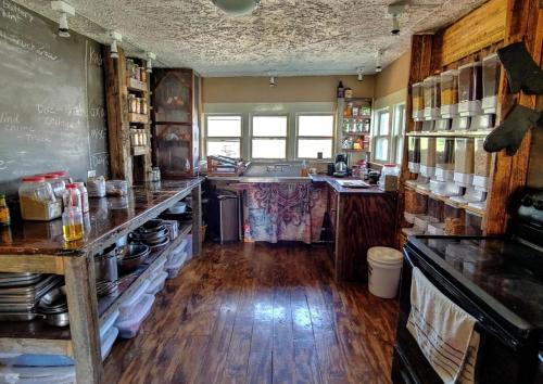 a large kitchen with wooden floors and a counter top at Lost River Hostel in French Lick