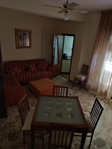 a living room with a table and chairs and a couch at Appartamento Elisa in Melito di Porto Salvo