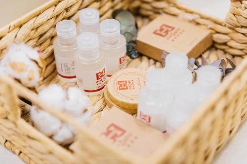 a basket filled with bottles of essential oils and cotton balls at Hotel Dukagjini in Peje