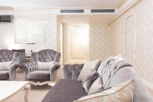 a living room with a couch and two chairs at Hotel Dukagjini in Peje