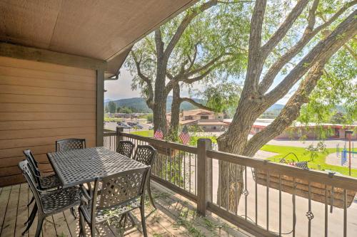 a table and chairs on a porch with a tree at Walkable Bigfork Townhome Fish, Hike and Ski! in Bigfork