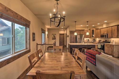 a dining room and kitchen with a wooden table and chairs at Walkable Bigfork Townhome Fish, Hike and Ski! in Bigfork