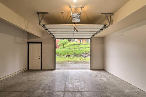 an empty room with an open door to a garage at Walkable Bigfork Townhome Fish, Hike and Ski! in Bigfork