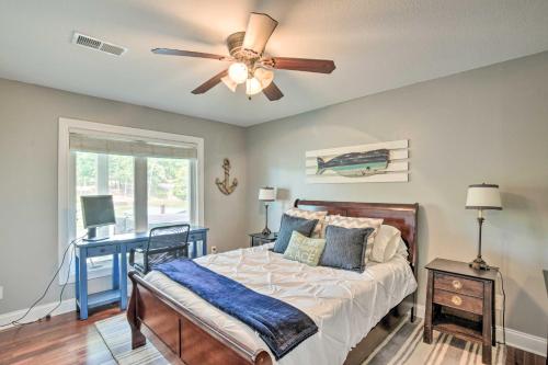 a bedroom with a bed and a ceiling fan at Waterfront Getaway with Fire Pit and Game Room! in Iva
