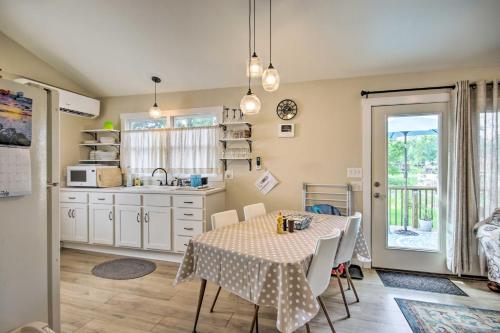 a kitchen with a table with chairs and a sink at Adorable Lakefront Cottage with Dock and Grill! in Lake Murray Shores