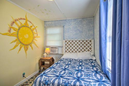 a bedroom with a bed with a sun mural on the wall at Adorable Lakefront Cottage with Dock and Grill! in Lake Murray Shores