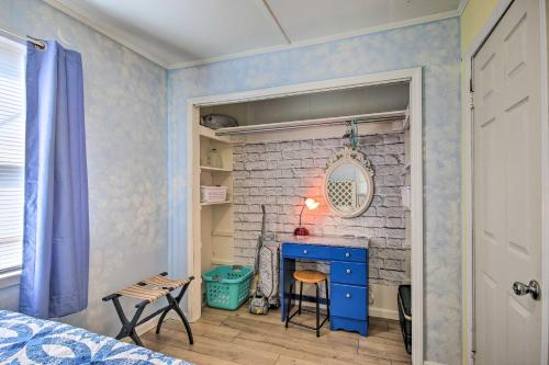 a room with a brick fireplace and a blue dresser at Adorable Lakefront Cottage with Dock and Grill! in Lake Murray Shores