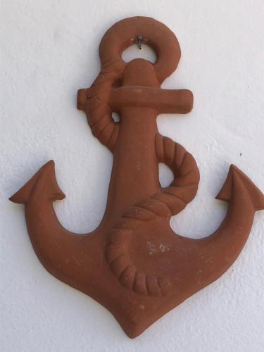 a brown metal object that looks like an anchor at Villa Jimmy, Pilona Village in vlicha