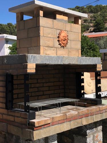 a brick oven with a clock on top of it at Villa Jimmy, Pilona Village in vlicha