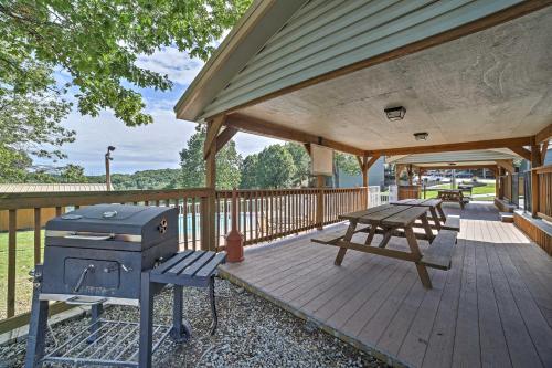 a patio with a grill and a picnic table at Reeds Spring Condo Near Aquarium at the Boardwalk! in Reeds Spring