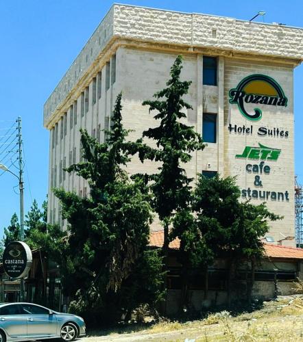 a car parked in front of a building at Rozana Hotel in Amman