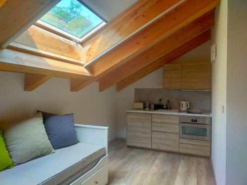 a kitchen with a skylight in a loft at Cascina Ghitin Relais in Asti