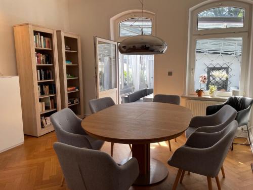 a dining room with a wooden table and chairs at Apartment Factory in Hamburg
