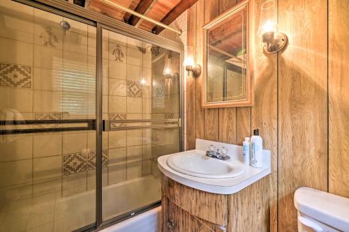 a bathroom with a sink and a shower at Game Room and Fire Pit Tree-Lined Pocono Lake Cabin in Pocono Lake