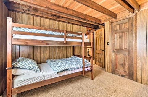 a bedroom with two bunk beds in a cabin at Game Room and Fire Pit Tree-Lined Pocono Lake Cabin in Pocono Lake
