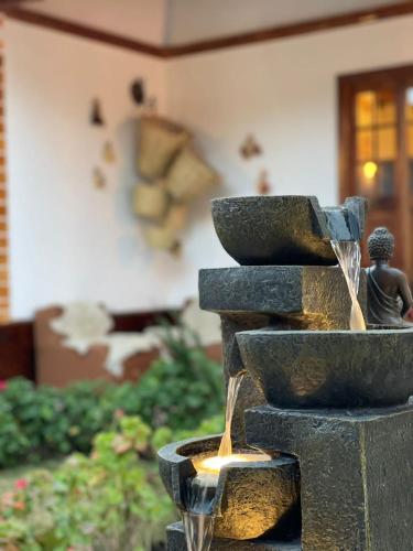 a fountain with a child sitting on top of it at CasaHotel Laguna Jauja Airport in Jauja