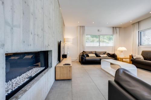 a living room with a large stone fireplace at Le Kube - Appartements de Prestige au centre d'Annecy in Annecy