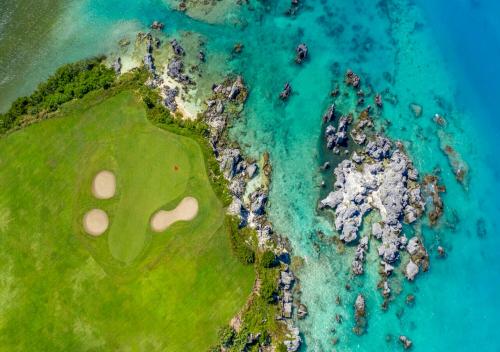 an aerial view of a golf course next to the ocean at St George's Club in Saint George
