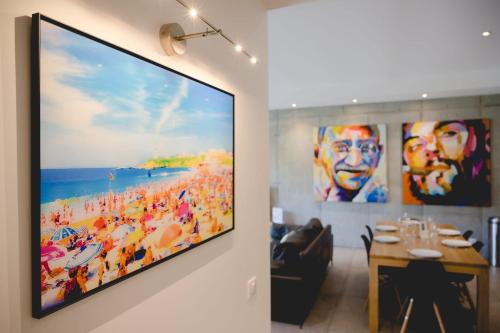 a television hanging on a wall in a restaurant at Le Kube - Appartements de Prestige au centre d'Annecy in Annecy