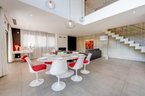 a dining room with a table and chairs and stairs at Le Kube - Appartements de Prestige au centre d'Annecy in Annecy