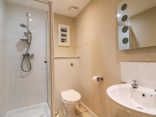 a bathroom with a shower and a toilet and a sink at Sea Breeze in Weymouth