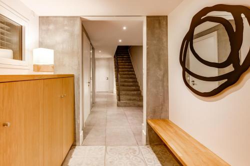 a hallway with a staircase in a house at Le Kube - Appartements de Prestige au centre d'Annecy in Annecy
