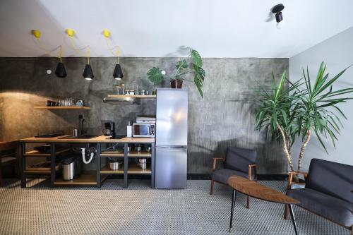 a kitchen with a stainless steel refrigerator and a table at Seaview holiday house Mali Rog in Zadar