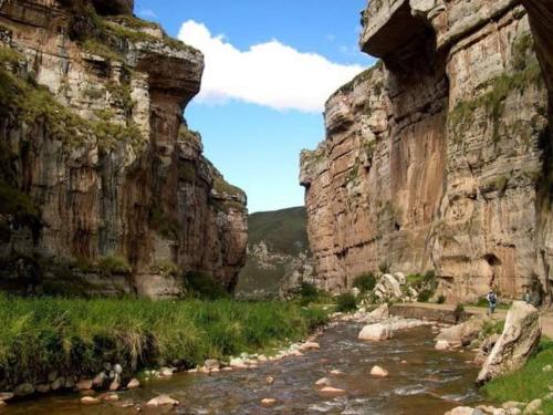 a river in a canyon with a rocky cliff at CasaHotel Laguna Jauja Airport in Jauja