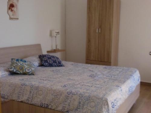 a bedroom with a bed with two pillows on it at DMZ - Agrigento Apartment in Agrigento