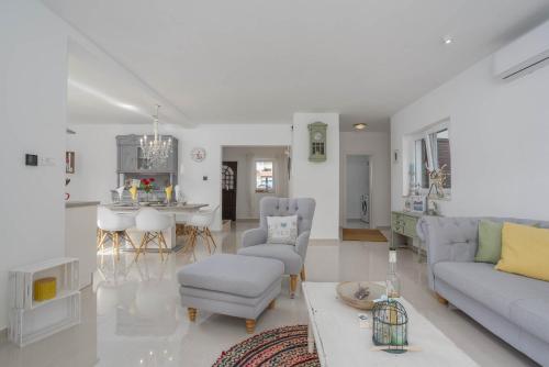 a living room with a couch and a table at Villa AntoNada in Krk
