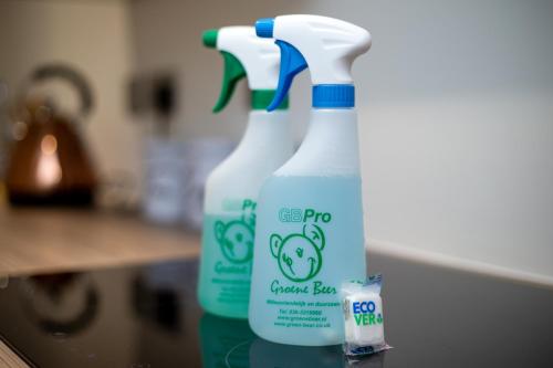 two bottles of cleaner bottles sitting on a counter at Stylish 'New York Loft' 2 Bed Apartment in Bradford
