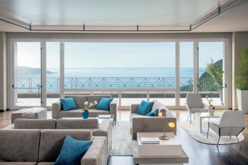 a living room filled with furniture and a balcony at Lefay Resort & Spa Lago Di Garda in Gargnano