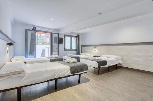 a hospital room with four beds and a window at HOSTAL BEDMATES in Barcelona